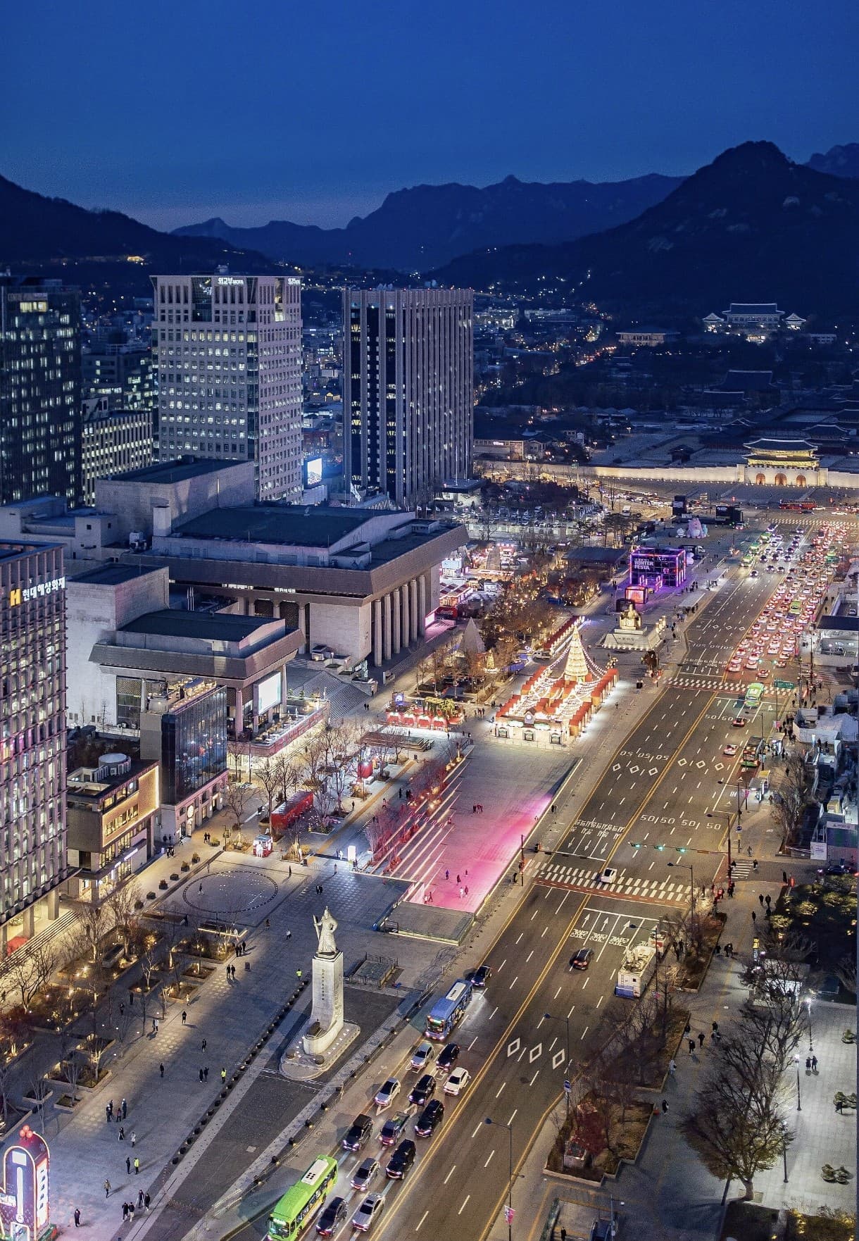Gwanghwamun Square at twilight with city lights, traffic, and winter festival illuminations